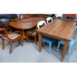 A modern pine plank top table on square tapering legs; a yew wood twin pedestal dining table with