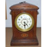 An inlaid oak mantel clock with floral dial and timepiece movement