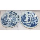 A pair of 19th century Chinese near matching shallow dishes decorated with flowers in blue and