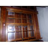 An Ethan Allen mahogany Townhouse Curio Cabinet with glazed wood framed shelves enclosed by glass