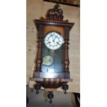 A 19th century small spring driven Vienna wall clock with horse finial and turned side column,