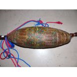 An unusual musical instrument with 3 strings and beaded decoration to the body and vellum cover