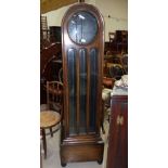 A 1930's oak longcase clock with glazed door and triple weight driven movement