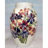 A Moorcroft large ovoid vase decorated with spring flowers against a white ground, impressed and