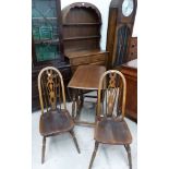 A period style dining suite comprising Dutch dresser with linen fold decoration, oval drop leaf