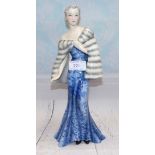 A Goldscheider figure designed by Claire Herczeg: woman in long blue dress and fur wrap, impressed