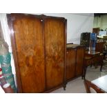 A 1930's walnut 3 piece bedroom suite comprising dressing table, wardrobe and tallboy