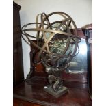 A modern solar lantern with multifaceted lens in armillary surround, having a figural support, 29½"