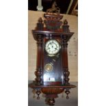 A 19th century spring driven Vienna wall clock with horse finial and turned side column, striking