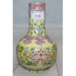 A Quien Lang style porcelain bottle vase with floral decoration o yellow ground, square seal mark to