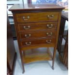 An Edwardian crossbanded mahogany music cabinet with 4 drawers and undertier