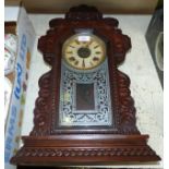 A 19th century American striking mantel clock; a tile teapot stand; an oak biscuit barrel