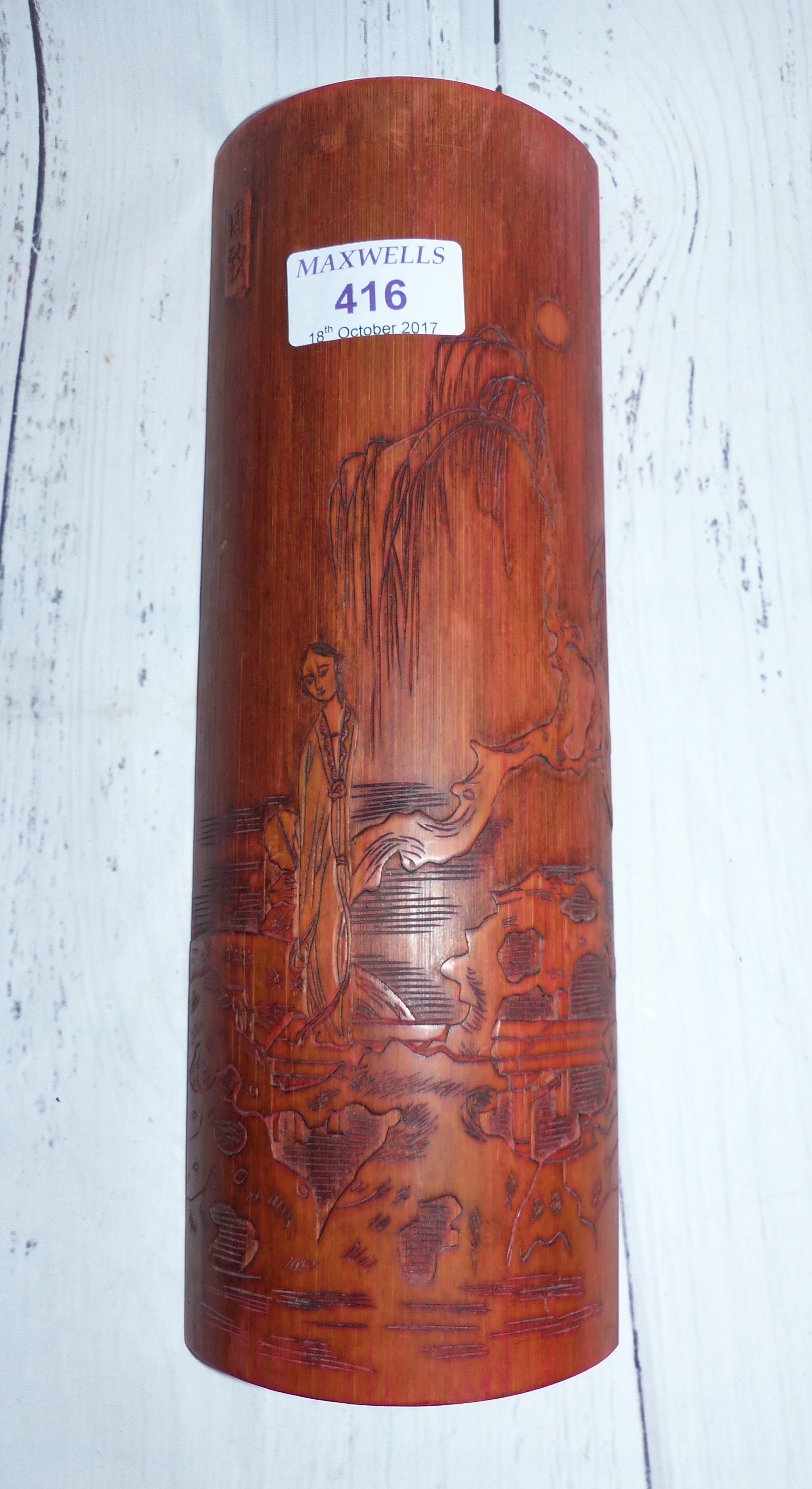 A 20th century carved bamboo panel decorated with a woman in landscape setting, 10½"