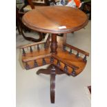 A Victorian mahogany tripod book table with circular top and galleried undertier