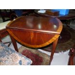 An Ethan Allen crossbanded mahogany oval Pembroke table in the Georgian Federal style, 28"