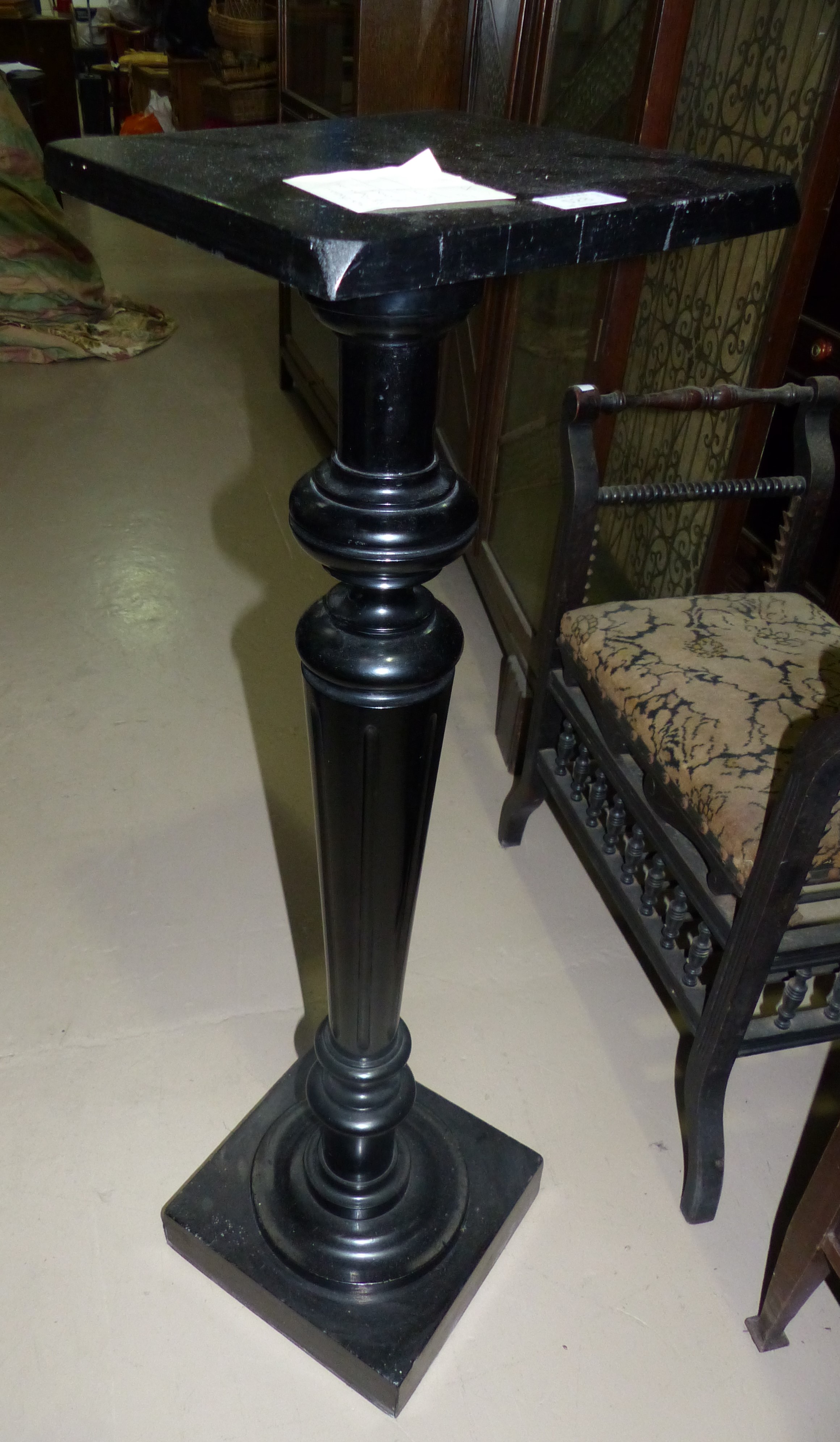 A Victorian ebonized torchere