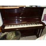 A mahogany upright piano by Schubert, iron framed and overstrung