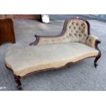 A Victorian carved walnut spoon back settee on cabriole legs
