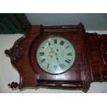 A 19th century mahogany longcase clock by Smith, Manchester, with carved crest and turned pillars to