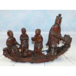 A 19th century Chinese carved wooden boat group with man and 3 children, length 12½"