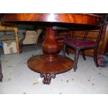 A Victorian figured mahogany circular tilt top table on octagonal baluster column, circular base and
