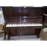 A mahogany upright piano by Schubert, iron framed and overstrung