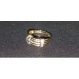 A ladies 9 carat hallmarked gold buckle ring banded with small diamonds