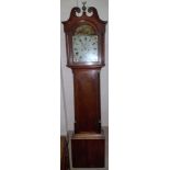 An early 19th century oak longcase clock with swan neck pediment and reeded columns to the hood,