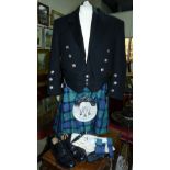 A Scottish tartan kilt in blue / green with sporran, black jacket , black waistcoat, socks etc