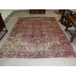 An early/mid-20th century Persian carpet, hand knotted, red ground with multiple border and large