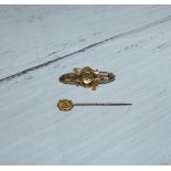 A bar brooch set with diamond chips; a stick pin, 3.2 gm gross