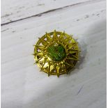 A 9 carat hallmarked gold sunburst brooch with inset diamond and green enamel decoration, 5.9 gm