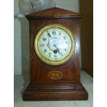 An inlaid oak mantel clock with floral dial and timepiece movement
