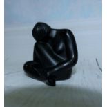 A black satin glass female figure, seated, signed in script 'Lalique France', height 2½"