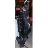 A set of golf clubs, bag and trolley