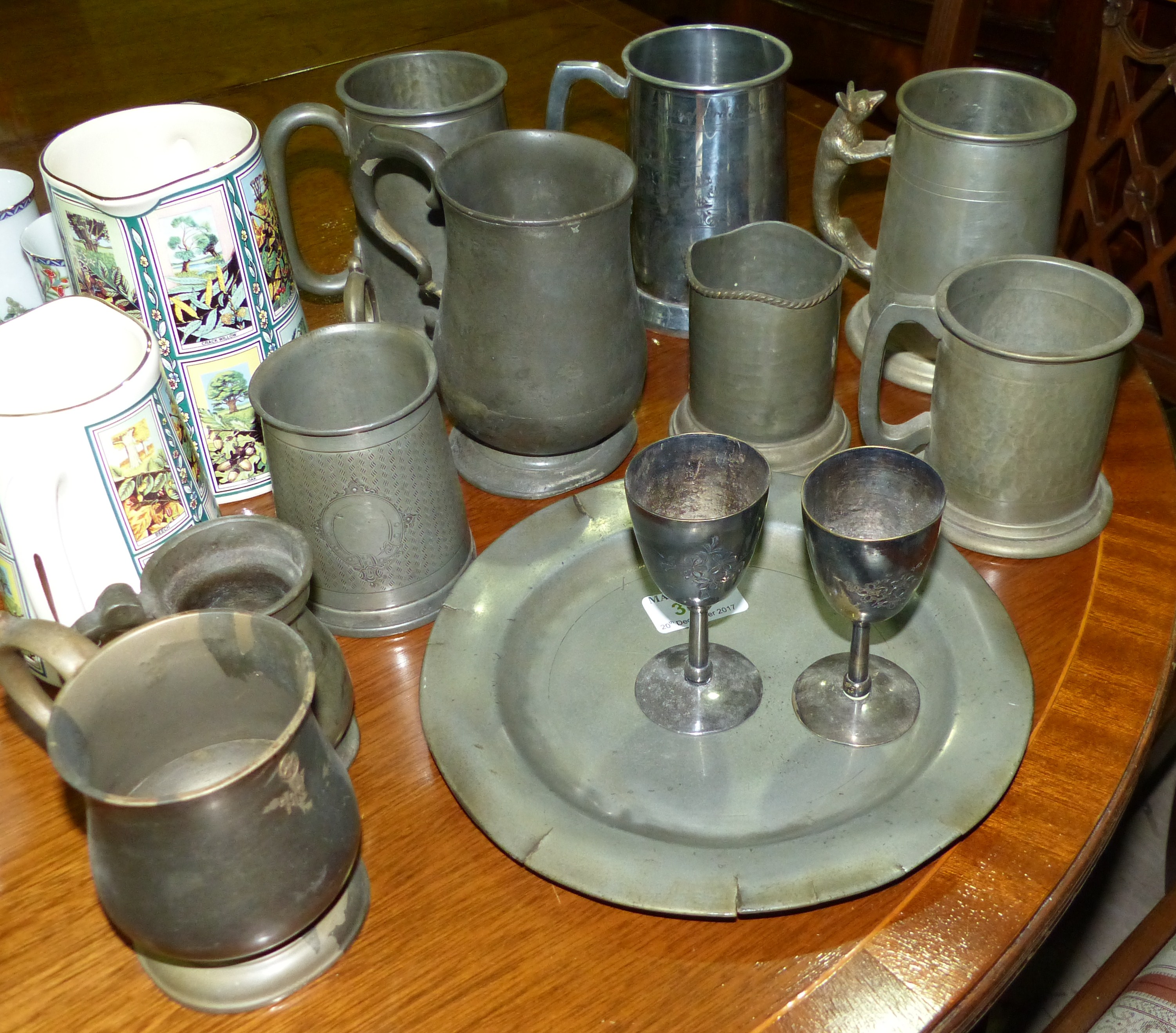 A selection of pewter mugs etc