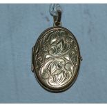 A chased oval locket, stamped '375'