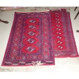 Two Persian hand knotted rugs with red grounds