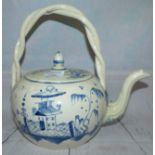 A large 18th century creamware teapot with chinoiserie decoration in blue and white, and intertwined