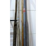 Four wooden oars of unusually long length