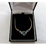 A 9ct pendant necklace set with five pear shaped blue topaz stones and a diamond. 4.3g gross