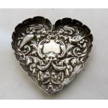 A Victorian silver heart shaped trinket dish decorated in repousse with birds and foliage. 3¾''