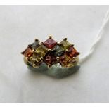 A fancy sapphire 10 stone cluster ring. In gold. Size L