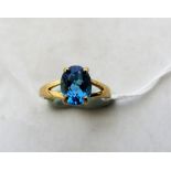 A Swiss blue topaz solitaire ring. In gold marked 375. Size M