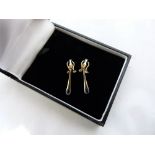 A pair of 9ct and sapphire set drop earrings