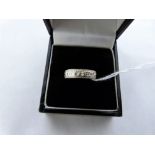 A wedding ring etched with flowers. In white gold marked 375. 1.9g