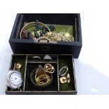 A leather jewellery box containing miscellaneous jewellery including a silver fob watch, amethyst