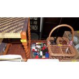 A rush seat stool, diecast vehicles, two cameras and a wicker bottle basket