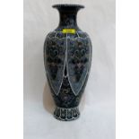 A Japanese inverted baluster vase decorated with reserved foliage on a green ground. 16'' high.