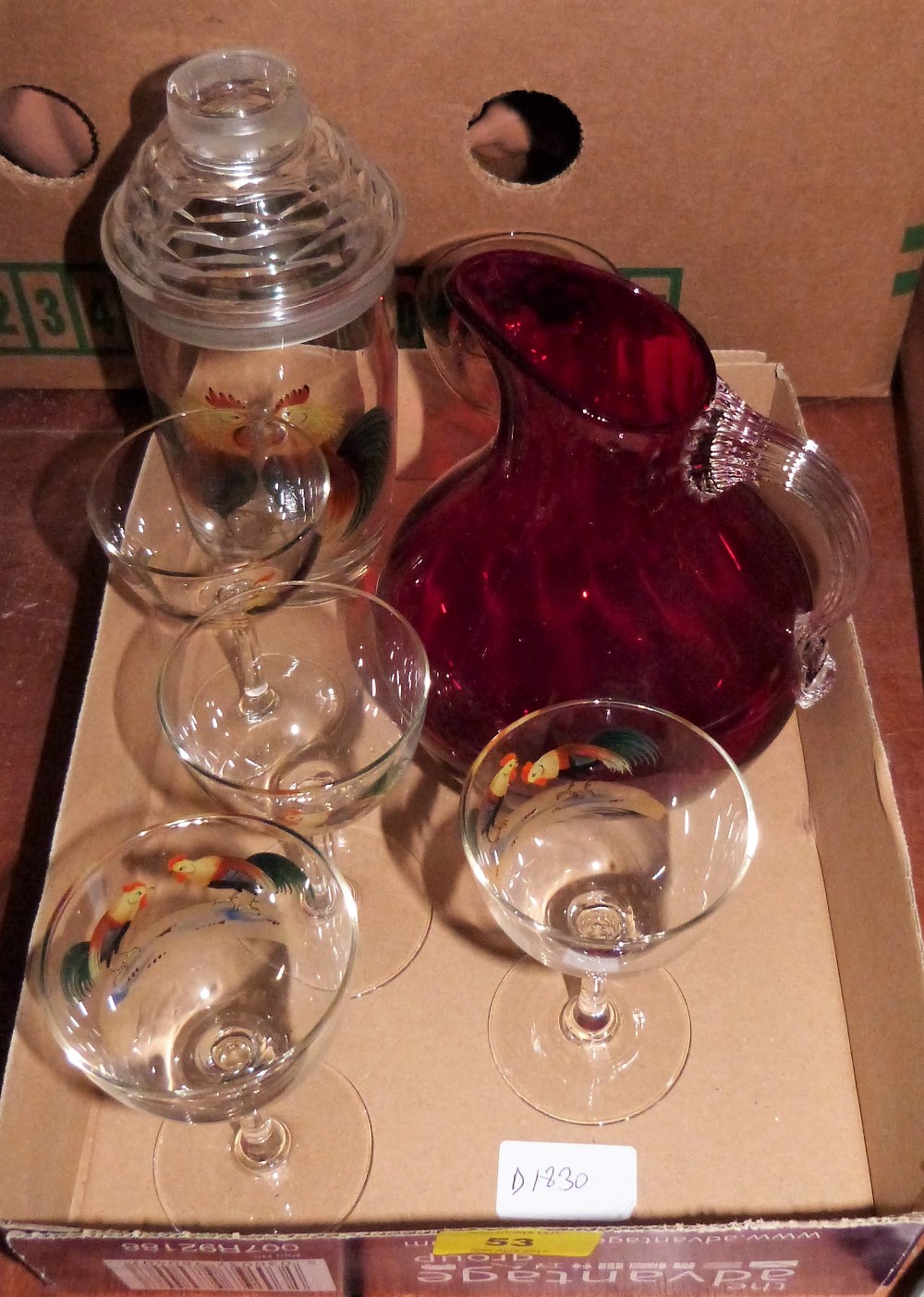 A 1950's glass cocktail shaker and five glasses with decoration of cockerels and a ruby glass jug